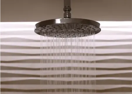 A rain shower head with falling water